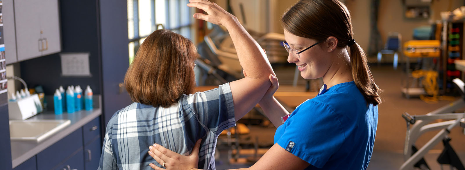 An occupational therapist working with a patient.