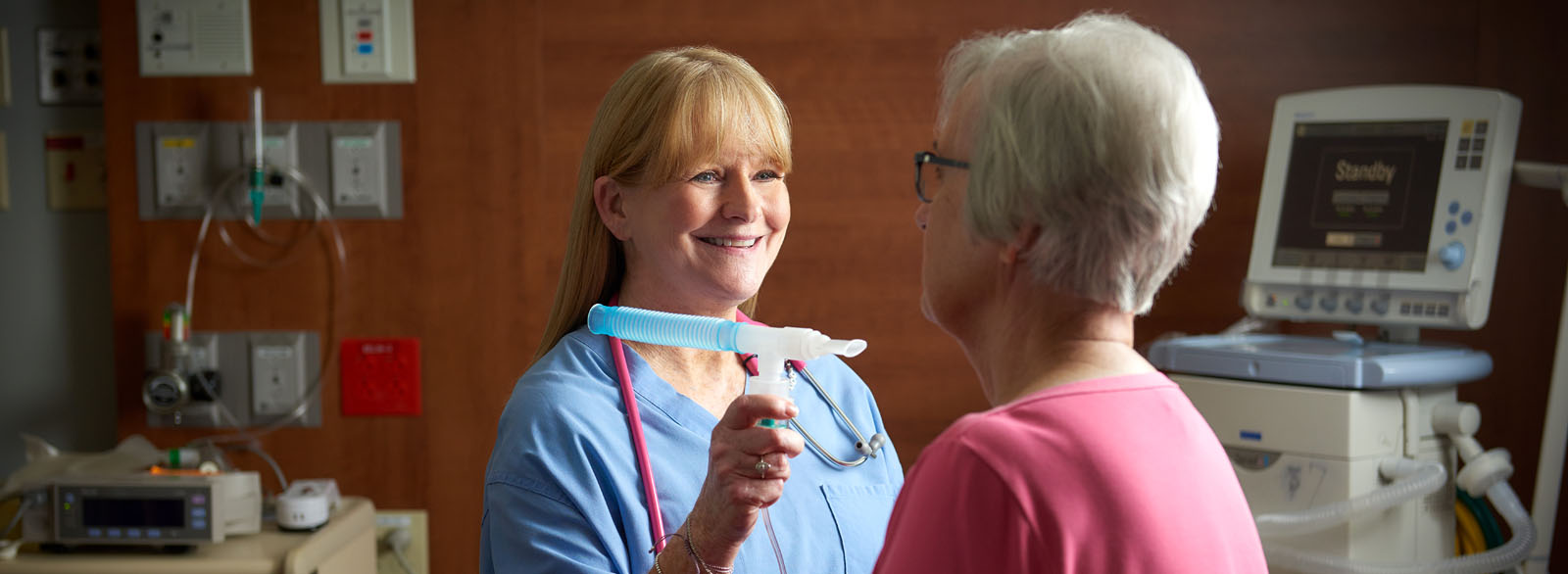 Respiratory therapist working with a patient.