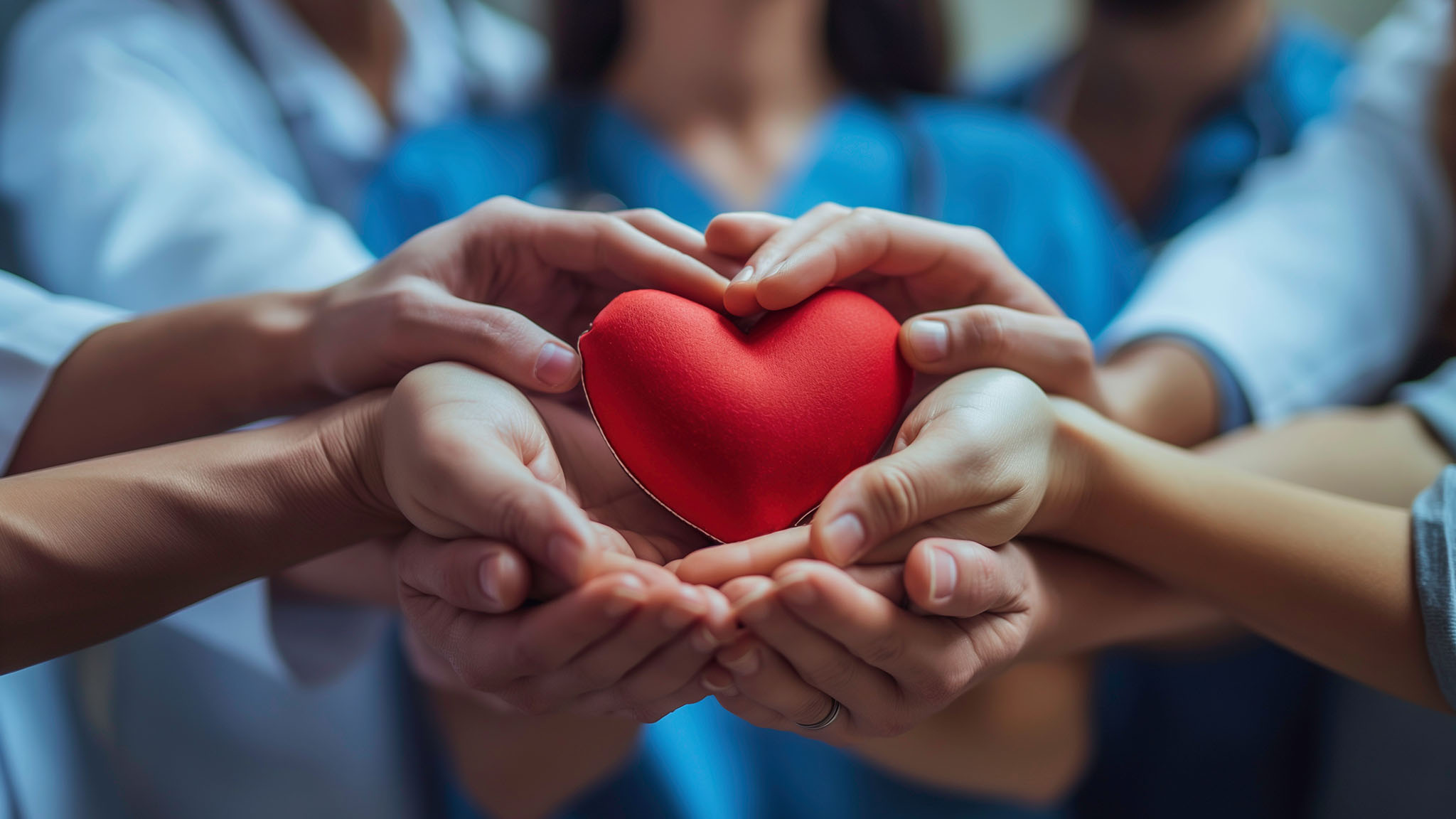 Group of healthcare worker's holding a heart.