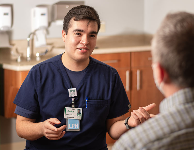 CRH Licensed Practical Nurse Carlos speaks with a patient.