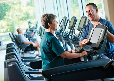 Wellness Center instructor working with participant Wellness Center instructor working with participant