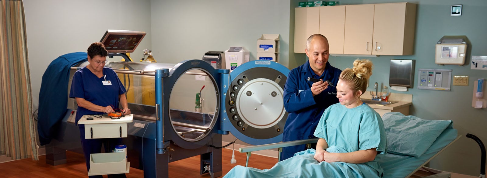 Physician and nurse preparing a patient for hyperbaric oxygen therapy at the Wound Center.