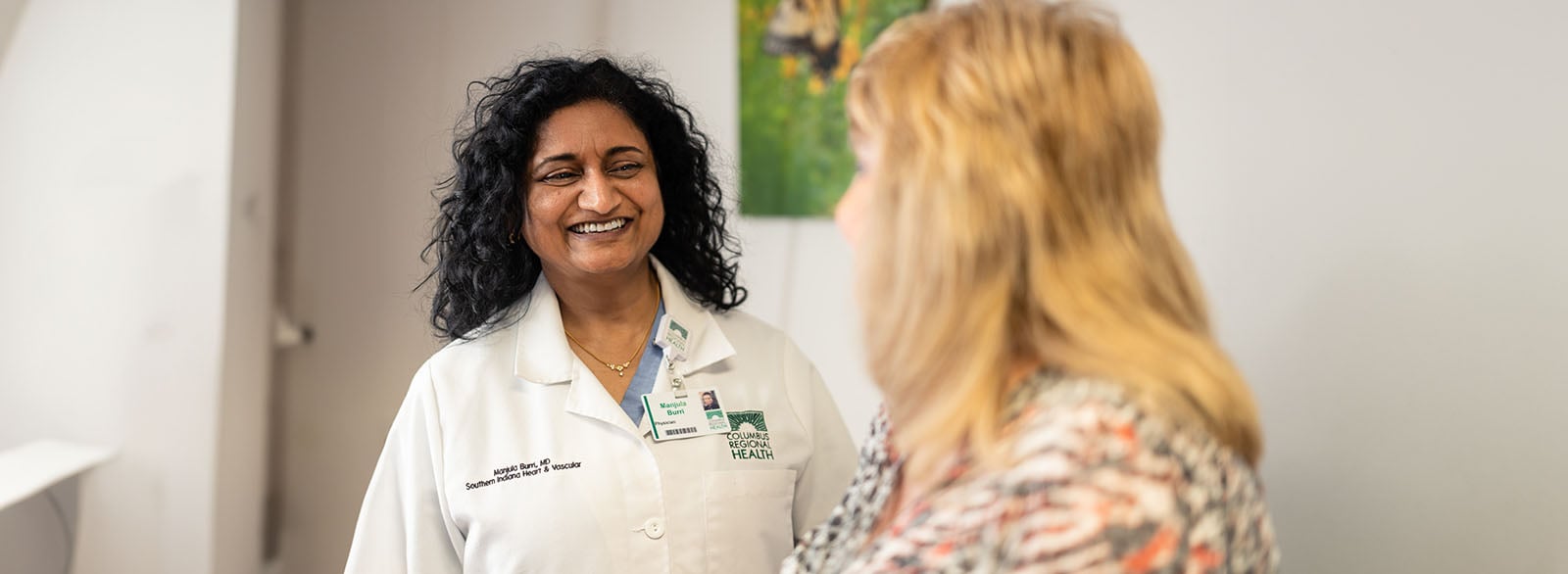 Dr. Manjula Burri of Southern Indiana Heart & Vascular visits with a patient.